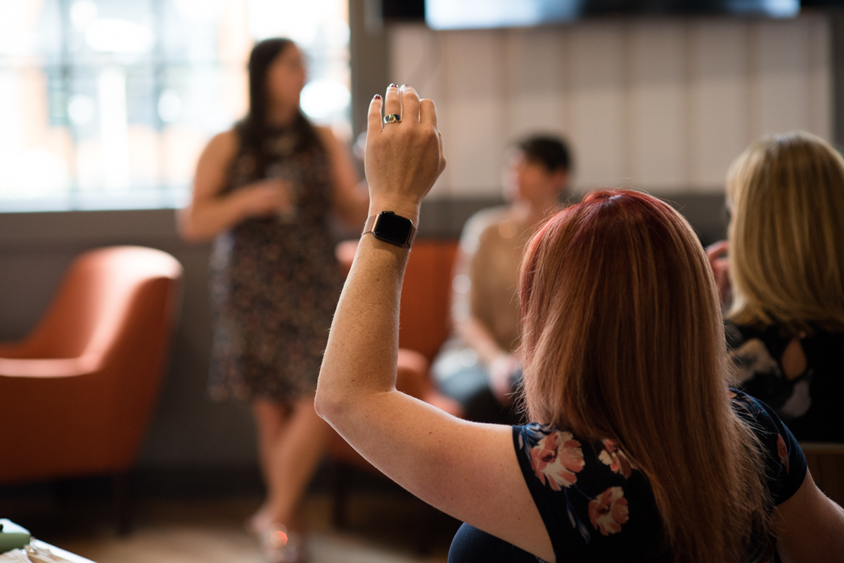 Member raising her hand in a peer circle